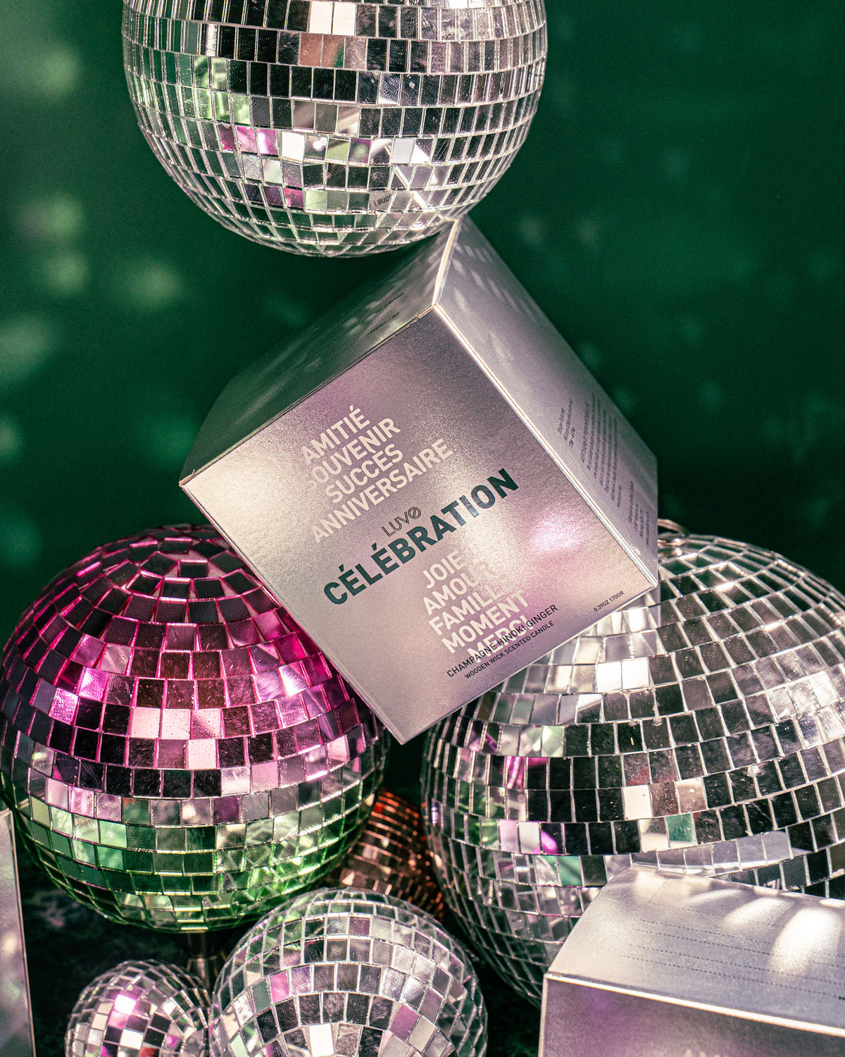 LUVO Célébration silver gift box, champagne hinoki ginger scented candle, with space for a gift message, among disco balls