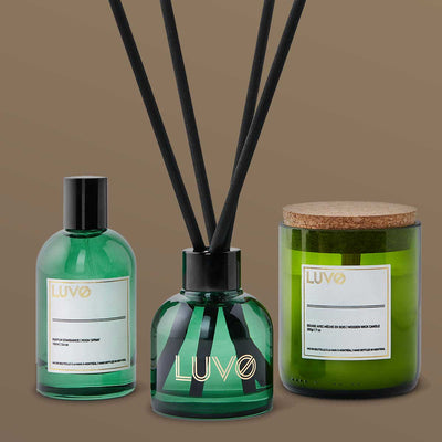 Cedarwood & Labdanum gift set trio: eau de parfum, reed diffuser and wooden wick candle on a taupe background