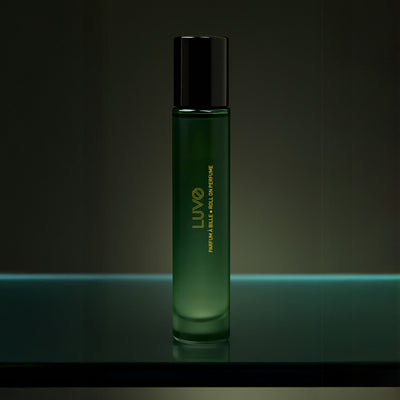 LUVO perfume roll-on 10ml, slim green glass bottle on a glass shelf