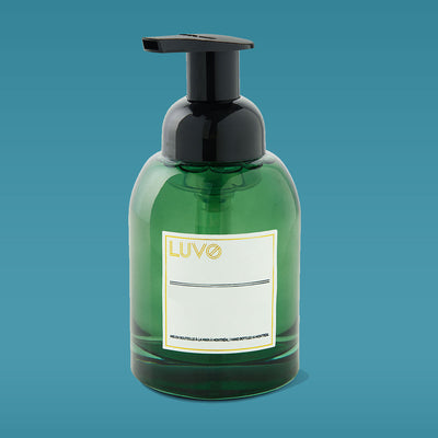 Baumier Fir & Balsam Spruce foaming hand soap 250ml in a green glass pump bottle on a blue background