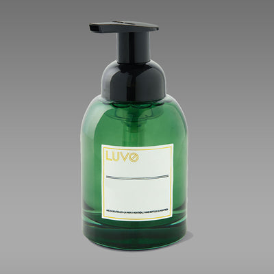 Cashmere & Vanilla foaming hand soap 250ml in a green glass pump bottle on a grey background