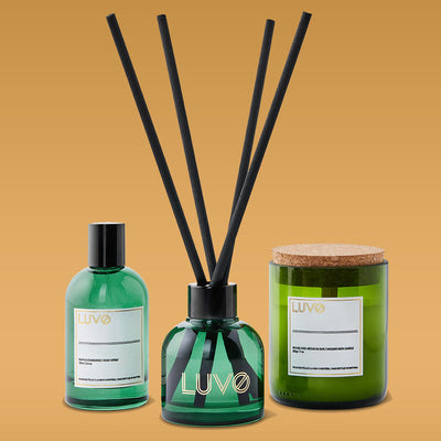 Mandarin & Resin gift set trio: eau de parfum, reed diffuser and wooden wick candle on an ochre background