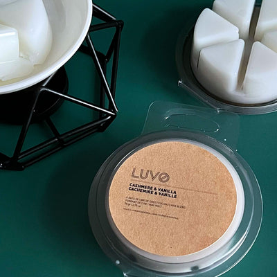 Cashmere & Vanilla 79g wax melt pack beside a white ceramic wax warmer